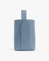 Leather bag with short strap and subtle seam detailing.
