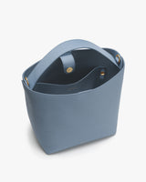 Open handbag with a handle and interior pocket.