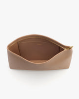 Open toiletry pouch with zippered compartment shown.
