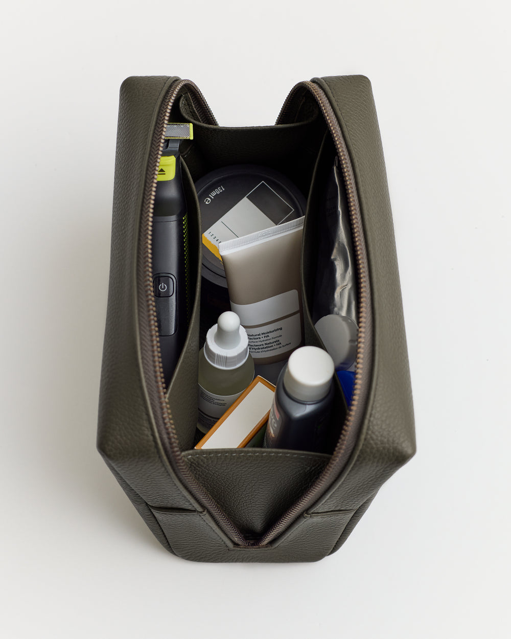 Open toiletry bag with various grooming products inside.