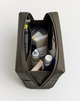 Open toiletry bag with various grooming products inside.