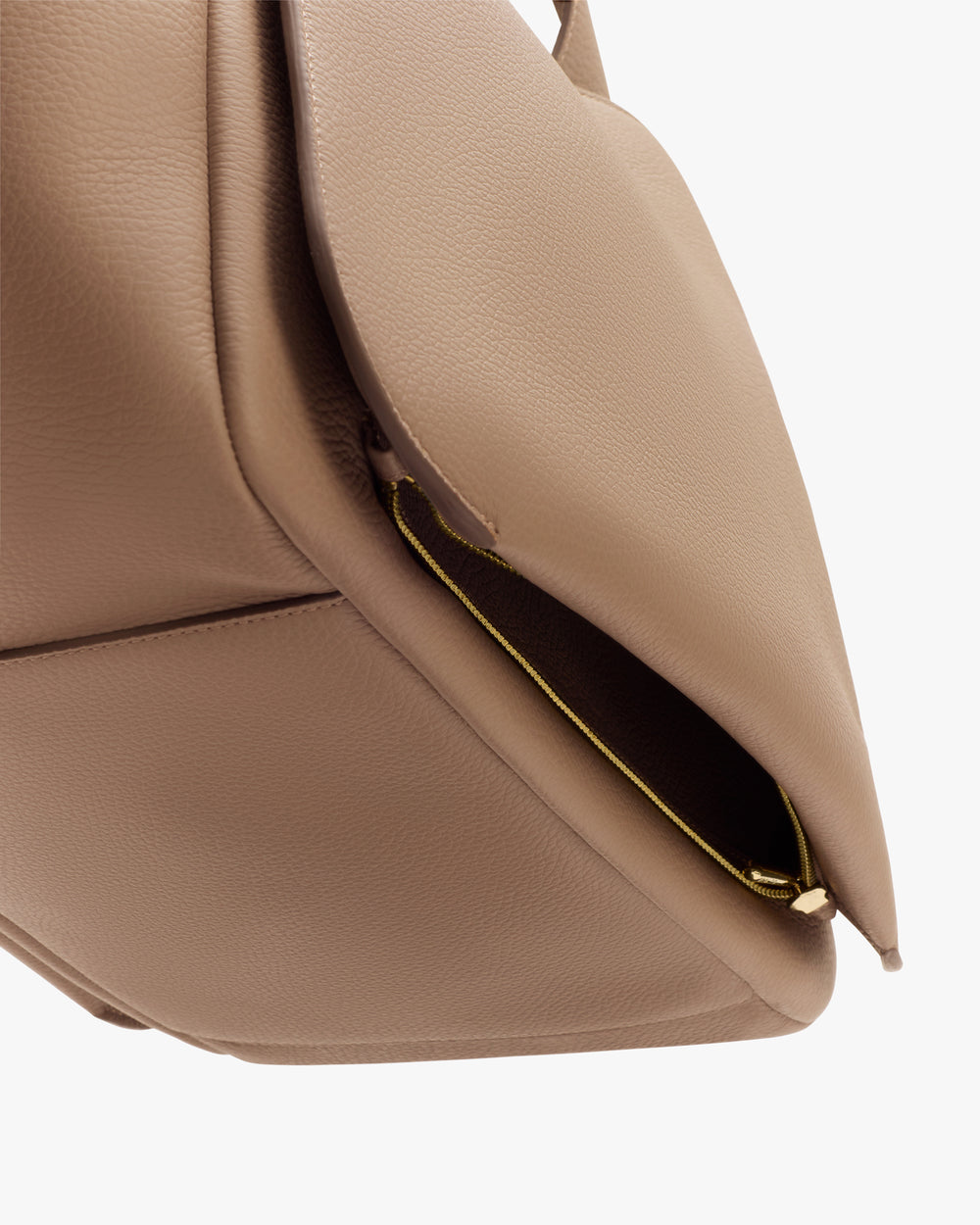 Close-up of an open handbag pocket with visible zipper.