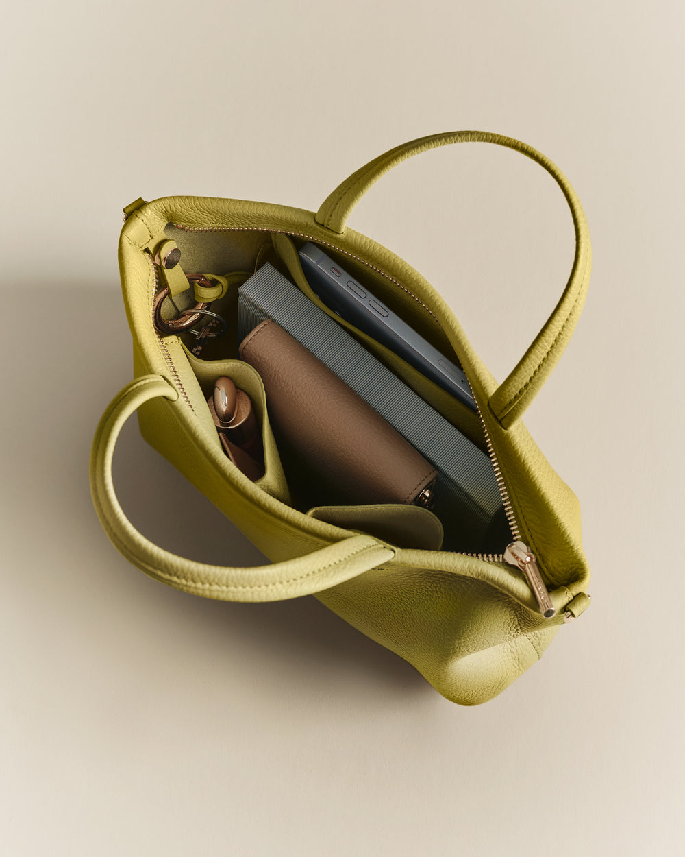 Open bag with book, pen, and a small pouch inside