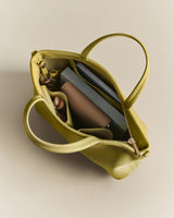 Open bag with book, pen, and a small pouch inside