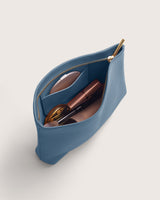Pouch with a zipper, holding various cosmetic items.