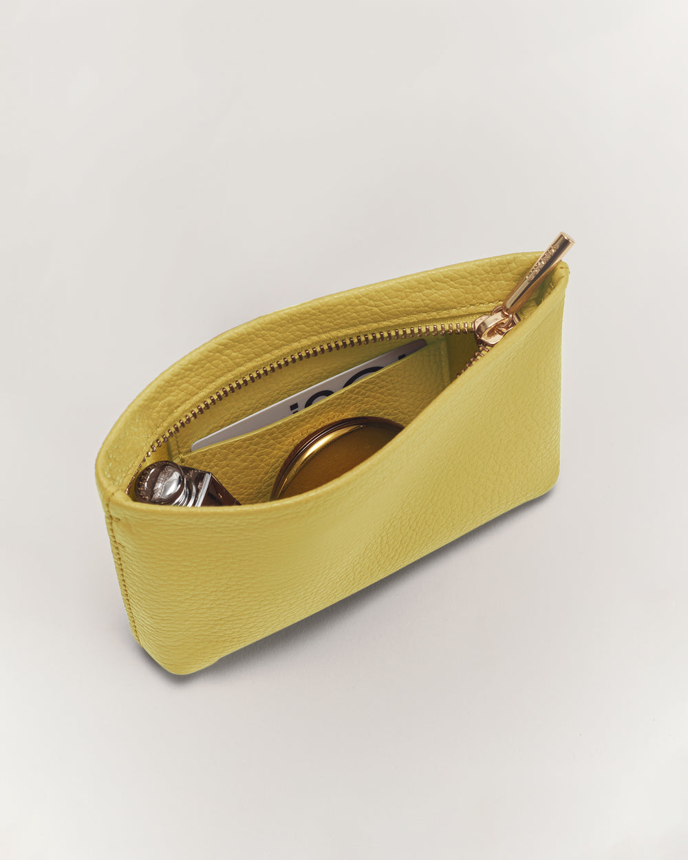 Small open zippered pouch with items inside.