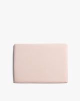 Rectangular folded fabric sheet against plain background.