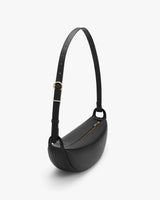 Minimalist shoulder bag with adjustable strap and zippered closure.