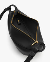 Open belt bag with a zip closure and a small interior pocket.