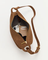 Open crossbody bag with phone, wallet, and keys inside.