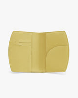 Open passport holder with card slots and pocket on white background.