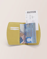 Open passport holder with passport and boarding pass visible.