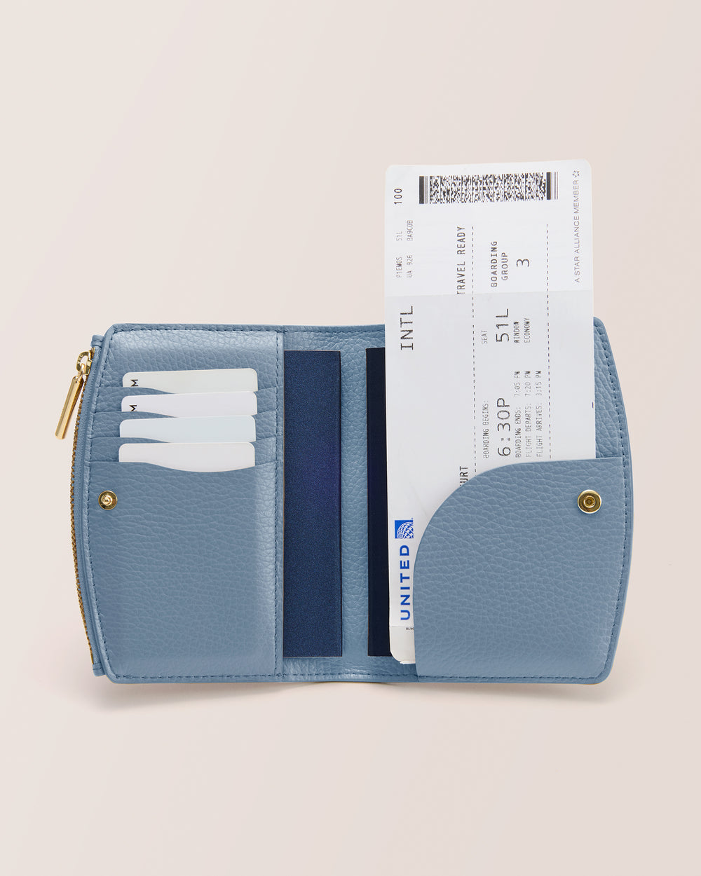 Open wallet with cards and a flight ticket visible inside.