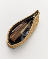 Open woven bag with wallet, phone, sunglasses inside.
