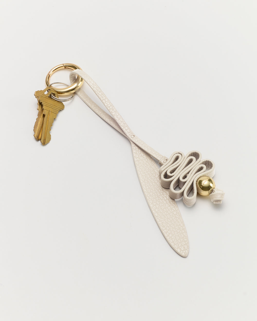 Keychain with keys and a looped decorative leather piece.