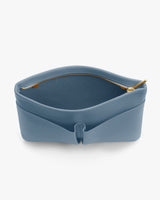 Open handbag with a zipper on the top edge, partially unzipped