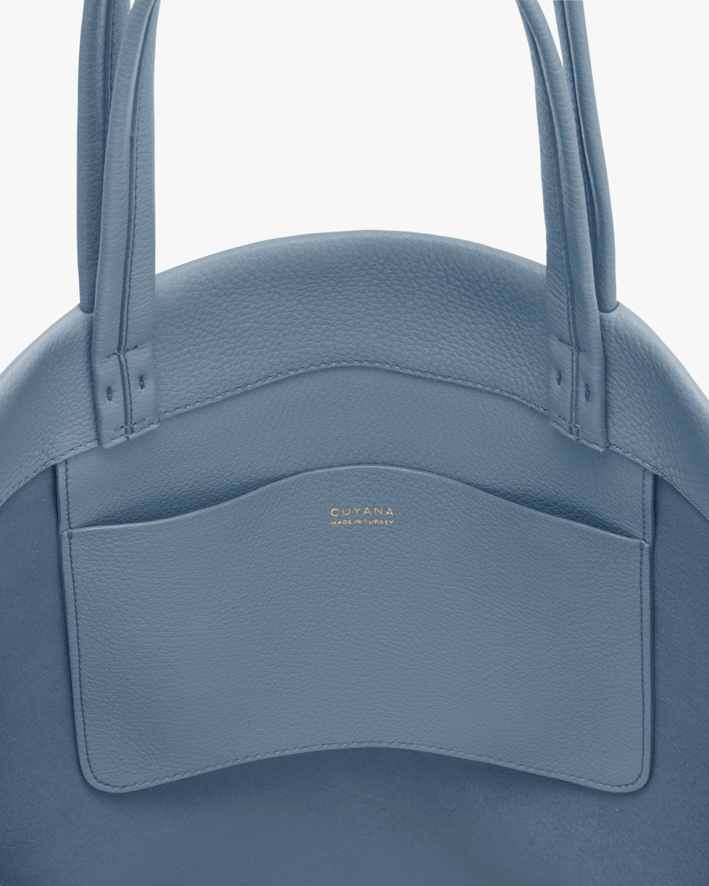 Close-up of a handbag with two handles and a small front pocket.
