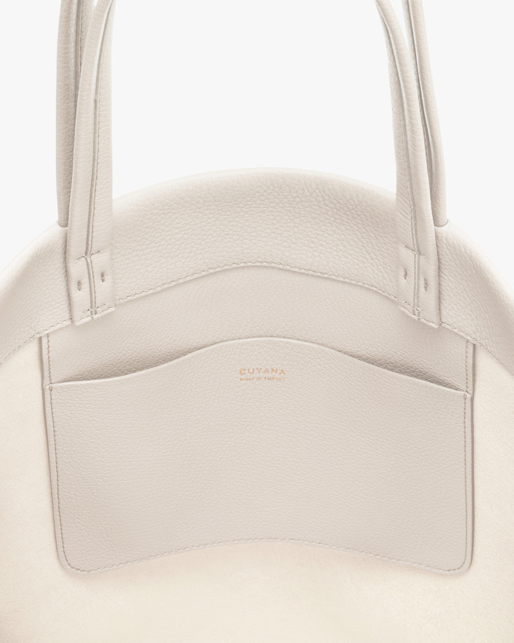 Close-up of a tote bag with a large front pocket and two handles.