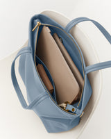 Open travel bag with a wallet and zippered compartment inside.