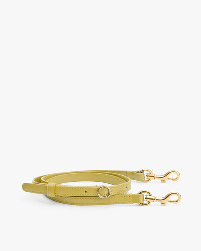 Adjustable bag strap with metal clasps and buckle.