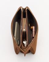 Open handbag with phone, keys, makeup, and a small zippered pouch inside.