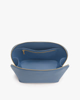 Open handbag with a zippered compartment inside.