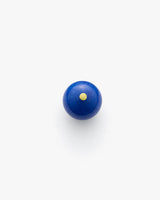 Round object with a small dot centered on top.