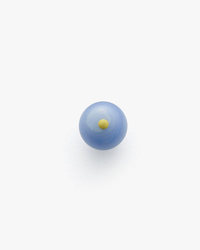 Blue marble with a small yellow dot in the center.
