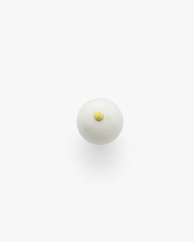 Round object with a small raised circular detail on top.