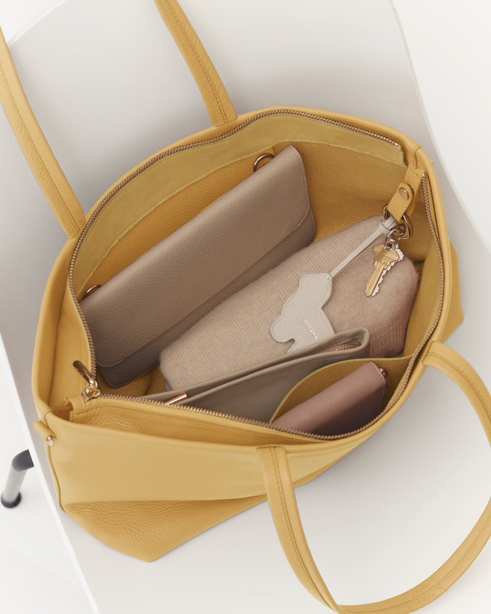 Open tote bag with organized interior pockets and a keychain clip.