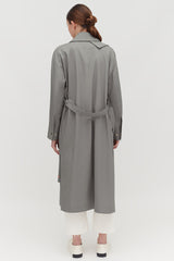 Person wearing a long coat and pants, viewed from the back.