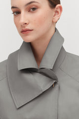 Person wearing a coat with a large collar facing forward.