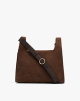 Suede shoulder bag with adjustable strap and circular buckle