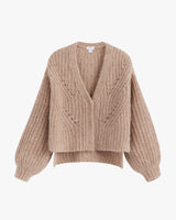 Knitted sweater with V-neck and button front on plain background