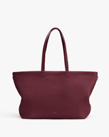 Large tote bag with long handles on a plain background