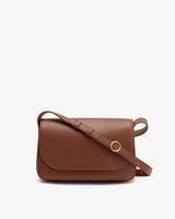 A small leather crossbody purse with a front flap and an adjustable shoulder strap.