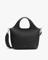 Handbag with two short handles and a detachable shoulder strap.