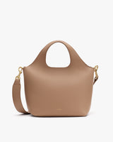 Handbag with a shoulder strap and short handles.