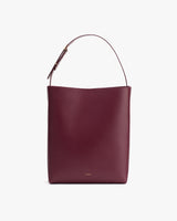 A bucket bag with a single shoulder strap and a minimalist design.