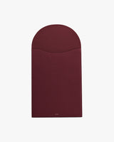 Rectangular leather laptop sleeve with a curved flap closure.