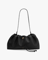 Shoulder bag with a gathered design and adjustable strap.