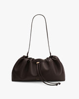 Gathered handbag with shoulder strap and drawstring closure.