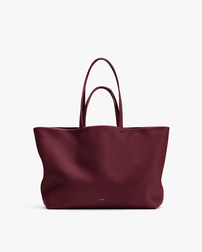 Large tote bag with handles displayed on a plain background