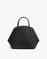 Geometric-shaped handbag with round handles.