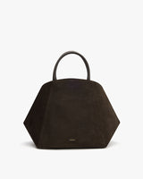 Geometric handbag with short handles on a plain background