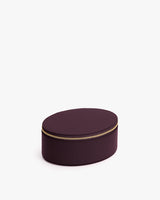 Oval-shaped zippered case on a plain background.
