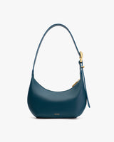 Shoulder handbag with a curved design and a buckle on the strap.
