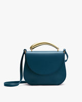 Handbag with curved handle and shoulder strap.