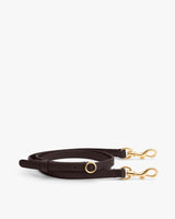 Leather strap with gold clasps and circular metal detail.