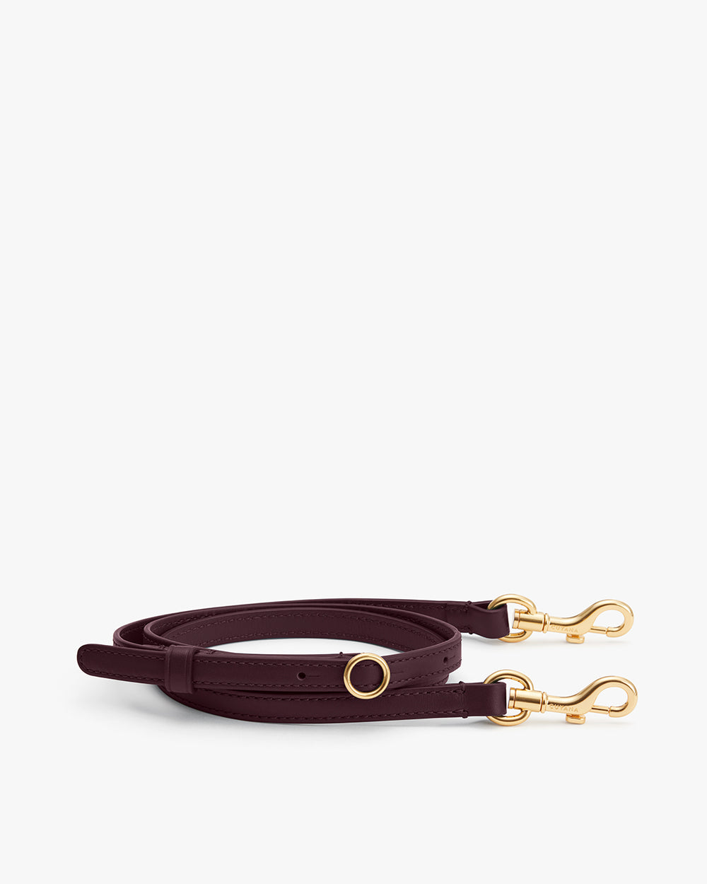 Adjustable shoulder strap with gold clasps placed on a plain background.